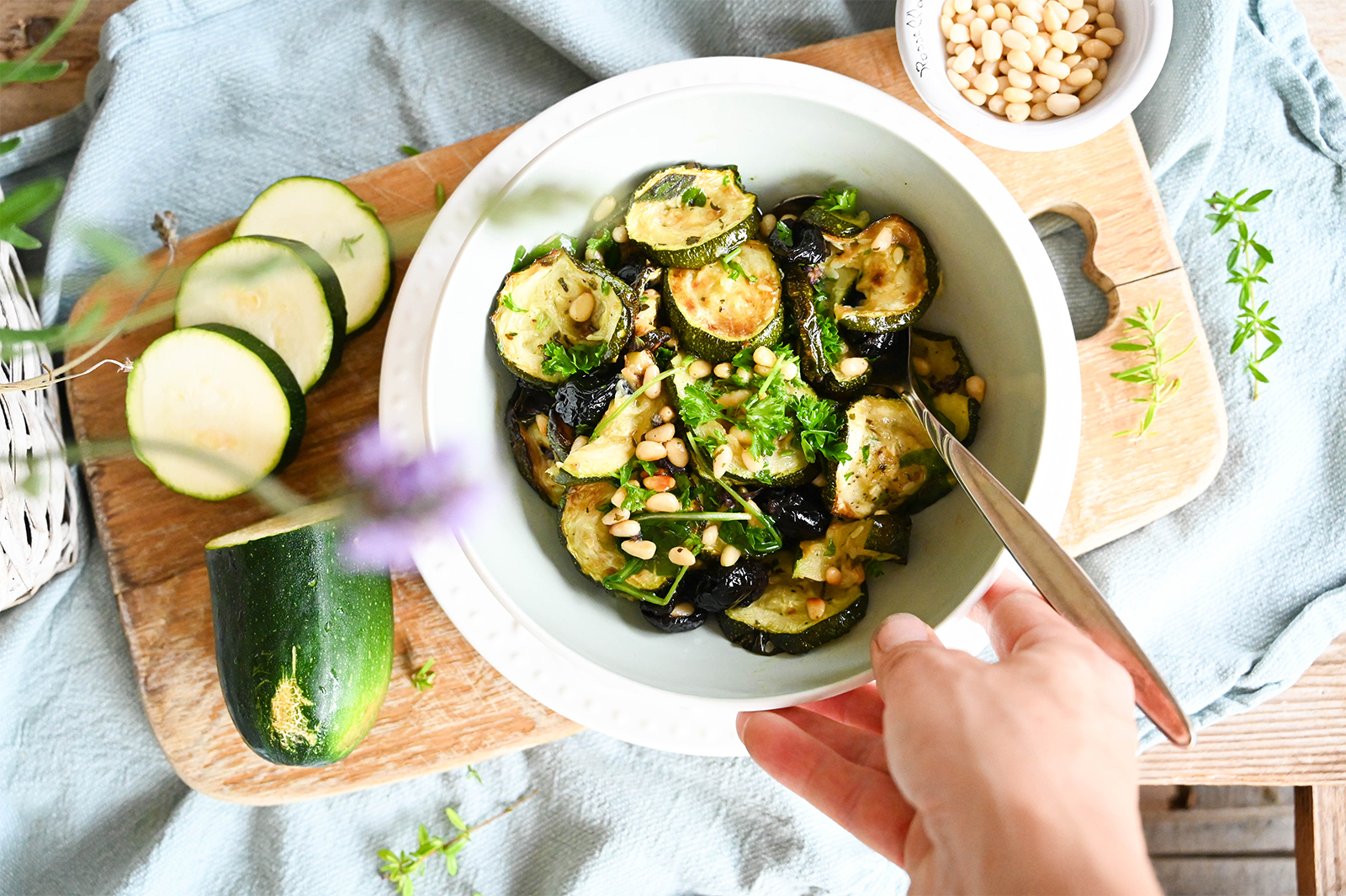Lauwarmer Zucchini-Salat mit Oliven und gerösteten Pinienkernen